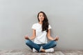 Beautiful young asian woman sitting in yoga position and meditating Royalty Free Stock Photo