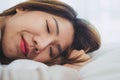 Beautiful young Asian woman sleeping in bed in the morning. Attractive asian girl use bedtime in her comfortable bedroom. Royalty Free Stock Photo