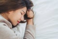 Beautiful young Asian woman sleeping in bed in the morning. Attractive asian girl use bedtime in her comfortable bedroom. Royalty Free Stock Photo