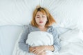 Beautiful young Asian woman sleeping in bed in the morning. Attractive asian girl use bedtime in her comfortable bedroom. Royalty Free Stock Photo