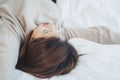 Beautiful young Asian woman sleeping in bed in the morning. Attractive asian girl use bedtime in her comfortable bedroom. Royalty Free Stock Photo