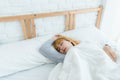 Beautiful young Asian woman sleeping in bed in the morning. Attractive asian girl use bedtime in her comfortable bedroom. Royalty Free Stock Photo