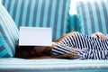 Beautiful young asian woman sleeping on sofa with book covering Royalty Free Stock Photo