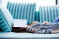 Beautiful young asian woman sleeping on sofa with book covering Royalty Free Stock Photo