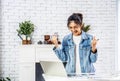 Beautiful young asian woman smiling celebrating success with arms up in front of laptop at home, Enjoying time Royalty Free Stock Photo