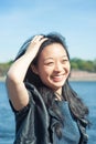 Beautiful young Asian woman smiling in the city at sunny day Royalty Free Stock Photo