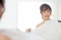 Beautiful young asian woman smiling with clothes trying on dress up fitting with modern and looking reflection mirror Royalty Free Stock Photo