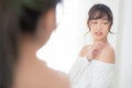 Beautiful young asian woman smiling with clothes trying on dressed up fitting with modern and looking reflect mirror in the room Royalty Free Stock Photo