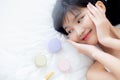 Beautiful of young asian woman smiling and lying on bed with cosmetic at bedroom, beauty of girl with hygiene and healthy. Royalty Free Stock Photo