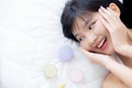 Beautiful of young asian woman smiling and lying on bed with cosmetic at bedroom, beauty of girl with hygiene and healthy. Royalty Free Stock Photo