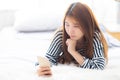 Beautiful young asian woman smiling lying relax on the bed in the morning Royalty Free Stock Photo