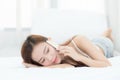 Beautiful young asian woman smiling lying and relax on the bed in the morning Royalty Free Stock Photo