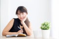 Beautiful young asian woman smiling sitting study and learning writing notebook and diary in the living room at home Royalty Free Stock Photo