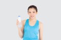 Beautiful young asian woman in sport after workout drinking water from bottle for thirsty isolated on white background, asia girl Royalty Free Stock Photo