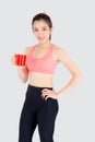 Beautiful young asian woman in sport after workout drinking water from glass for thirsty isolated on white background Royalty Free Stock Photo