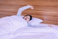 Beautiful young asian woman stretching and yawning in bedroom after wake up in the morning Royalty Free Stock Photo