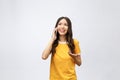 Beautiful young asian woman talking mobile phone and smile standing on grey background, freelancer female calling Royalty Free Stock Photo