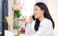 Beautiful young asian woman talking phone and smile in the coffee shop Royalty Free Stock Photo