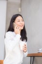 Beautiful young asian woman talking phone and smile in the coffee shop. Royalty Free Stock Photo