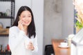 Beautiful young asian woman talking phone and smile in the coffee shop Royalty Free Stock Photo