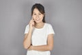 Beautiful young asian woman talking smart phone and smile standing on grey background Royalty Free Stock Photo