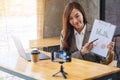 A beautiful young woman teaching business class online with laptop computer on the table Royalty Free Stock Photo