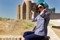 Beautiful young asian woman tourist in front of Mausoleum of Khoja Ahmed Yasawi. Central asia silk road tour