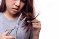 Beautiful young asian woman trimming or cutting her split ends of hair ends. Attractive beautiful young lady get problems of her Royalty Free Stock Photo