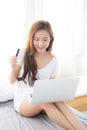Beautiful young asian woman users credit card with laptop, Content girl shopping online and payment with notebook computer Royalty Free Stock Photo