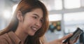 Beautiful young Asian woman using smartphone in home office, happy smiling. People lifestyle, internet communication technology Royalty Free Stock Photo