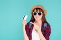 Beautiful young asian woman wear hat and sunglasses with showing and pointing credit card to travel summer trip Royalty Free Stock Photo