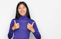 Beautiful young asian woman wearing casual clothes success sign doing positive gesture with hand, thumbs up smiling and happy Royalty Free Stock Photo