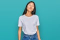 Beautiful young asian woman wearing casual white t shirt looking at the camera blowing a kiss on air being lovely and sexy Royalty Free Stock Photo