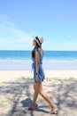 Beautiful young asian woman wearing hat walking on the beach in tropical sea Royalty Free Stock Photo