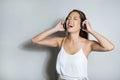 Beautiful young asian woman listening to music with headphones Royalty Free Stock Photo