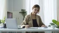 Beautiful young asian woman working with computer at bright modern office Royalty Free Stock Photo