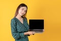 Beautiful young Asian woman working on laptop computer over yellow background, attractive girl excited surprise something while Royalty Free Stock Photo