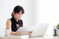 Beautiful young asian woman working and typing with laptop computer at office Royalty Free Stock Photo