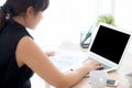 Beautiful young asian woman working and typing with laptop computer at office, businesswoman looking graph diagram analysis Royalty Free Stock Photo