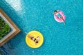 Beautiful young asian woman with yellow inflatable ring relaxing in swimming pool. top view Royalty Free Stock Photo