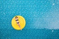 Beautiful young asian woman with yellow inflatable ring relaxing in swimming pool. top view Royalty Free Stock Photo