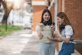 Beautiful young Asian woman college student with friends at outdoors. College student working on the college campus Royalty Free Stock Photo
