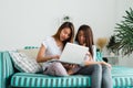 Beautiful young asian women LGBT lesbian couple sitting on sofa buying online using laptop a computer and credit card. Royalty Free Stock Photo