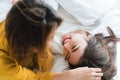 Beautiful young asian women LGBT lesbian happy couple hugging and smiling while lying together in bed under blanket at home. Royalty Free Stock Photo