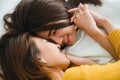 Beautiful young asian women LGBT lesbian happy couple hugging and smiling while lying together in bed under blanket at home. Royalty Free Stock Photo