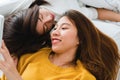 Beautiful young asian women LGBT lesbian happy couple hugging and smiling while lying together in bed. Royalty Free Stock Photo