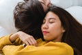 Beautiful young asian women LGBT lesbian happy couple hugging and smiling while lying together in bed under blanket at home. Royalty Free Stock Photo
