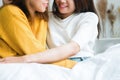 Beautiful young asian women LGBT lesbian happy couple sitting on bed hugging and smiling together in bedroom at home. Royalty Free Stock Photo