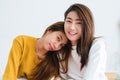Beautiful young asian women LGBT lesbian happy couple sitting on bed hugging and smiling together in bedroom at home. Royalty Free Stock Photo