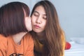 Beautiful young asian women LGBT lesbian happy couple sitting on bed hugging and smiling together in bedroom at home. Royalty Free Stock Photo